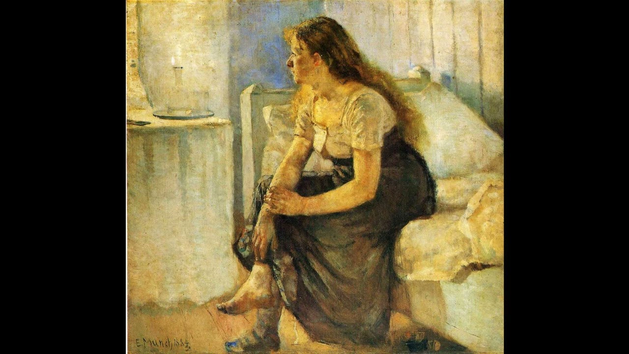 sentada al borde de la cama